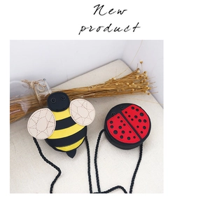 Detail of bee and ladybug kids crossbody bags in PU leather with cute woven straps
