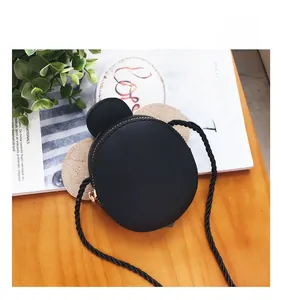 Detail of Mickey-style kids black round leather bag with ears and adjustable strap