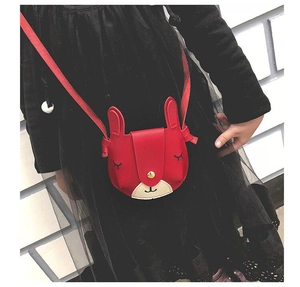 Close-up of cute red rabbit-shaped crossbody bag for girls with 3D ears and embroidery
