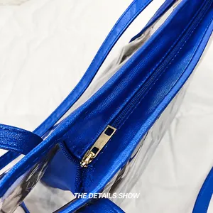 Makro-Detail des blauen Reißverschlusses und silbernen Schiebers an der transparenten Tasche