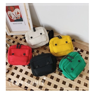 Flat lay of colorful children's canvas bags in white yellow red black and green