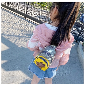 Détail du sac de poitrine dinosaure pour enfant avec poche jaune et broderie