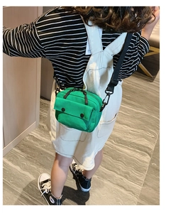Detailed view of kids bright green canvas crossbody bag with adjustable strap