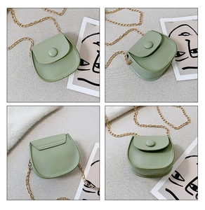 Detail view of mini round crossbody bag in sage green with gold chain and matte PU leather