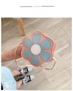 Detailed shot of pink and blue flower-shaped mini PU leather crossbody bag for girls