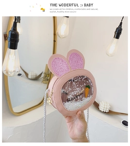 Detail of pink rabbit ear kid's crossbody bag with star sequins and carrot window