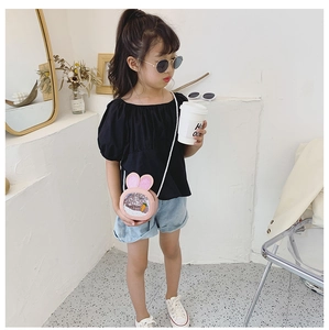 Pink rabbit ears crossbody bag with sequins and carrot detail shown on a young child