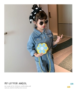 Detail view of child wearing denim jumpsuit with a yellow flower crossbody bag
