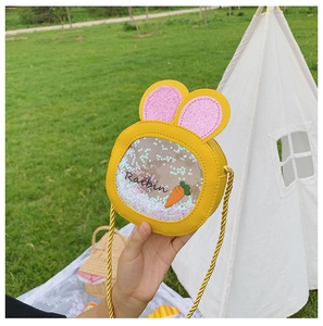 Detail of yellow rabbit ears bag with glitter carrot sequins and gold woven strap