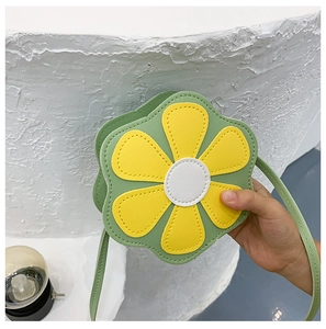 Detailed view of the yellow flower petal design on a green PU leather kid's crossbody bag