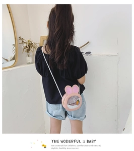Pink rabbit-shaped toddler crossbody bag with sequins and carrot decor shown on a model