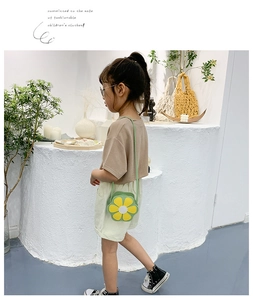 On-model view of a girls' daisy flower crossbody bag in green and yellow colors