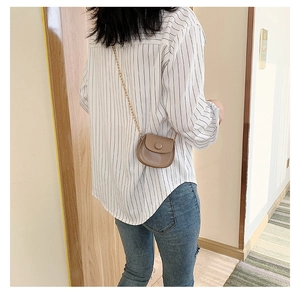 Back view of a mini brown faux leather crossbody bag for girls with a gold chain strap