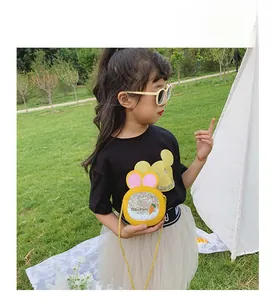 Girl wearing a cute yellow rabbit ear crossbody bag with sequins and carrot design