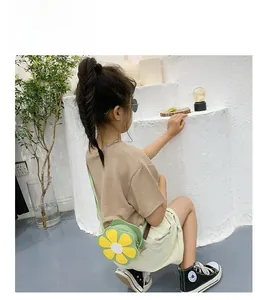 Detail of a floral crossbody bag for girls in green and yellow with soft leather texture