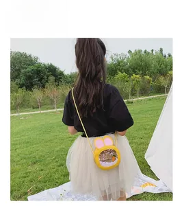 Detailed view of the yellow rabbit ear crossbody bag with sequins worn with a mesh skirt