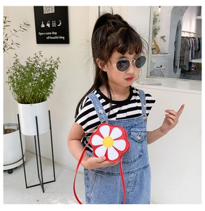 Girl's red flower crossbody bag styled with a casual striped shirt and denim overall outfit