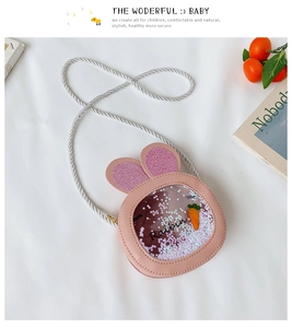 Detail of pink bunny ear bag with liquid star sequins and orange carrot decorations