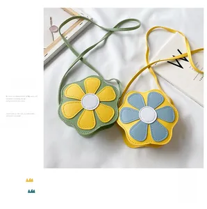 Detail of flower-shaped kids crossbody bags in mint and yellow PU leather texture