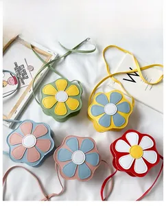 Flat lay of colorful flower-shaped PU leather crossbody bags for girls in five colors