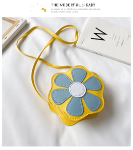 Detailed top view of a yellow floral girl's crossbody bag with blue and white petals