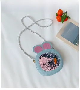 Detail of light blue kid's bunny ear crossbody bag with sequins and carrot decor