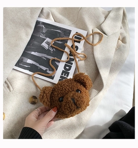 Close-up of soft brown teddy bear plush crossbody bag texture and woven shoulder strap