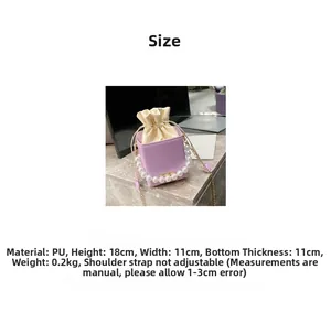 Detail view of purple PU bucket bag with large pearl handle and size 18x11x11cm