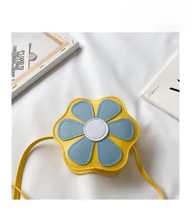 Detail of yellow flower mini crossbody bag for girls with blue petals and PU leather finish