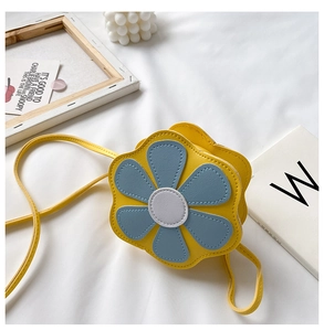 Detail of yellow flower crossbody bag for girls with blue and white petals and strap