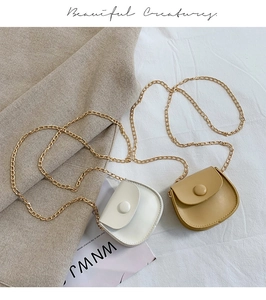 Detail of mini round chain bags in cream and khaki faux leather with gold metal straps