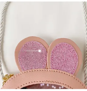 Detail of pink bunny ears with glitter and transparent PVC star sequins on girl's purse
