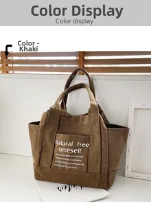 Detail of khaki corduroy tote bag featuring large front pocket and white motivational text