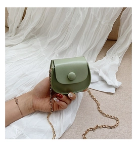 Detailed view of sage green leather mini round crossbody bag with gold chain strap