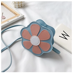 Detailed view of light blue flower-shaped PU leather crossbody bag for girls with pink petals