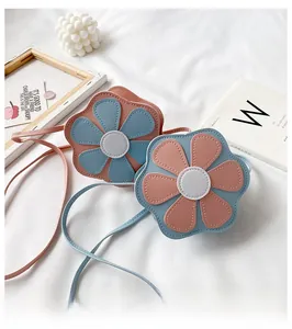 Detail view of flower-shaped crossbody bags for girls in pink and blue PU leather