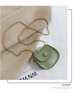 Close-up of avocado green mini PU leather crossbody bag with elegant gold chain strap