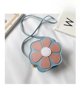 Detail of flower shaped girl crossbody bag with blue PU leather and gold zipper