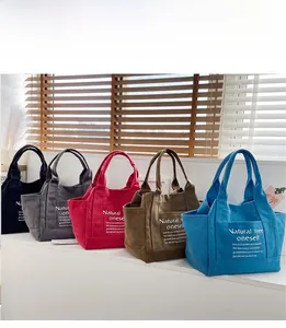 Detailed display of thick canvas tote bags in five colors with side functional pockets