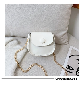 Detail of cream mini crossbody bag featuring fine synthetic leather and gold chain strap