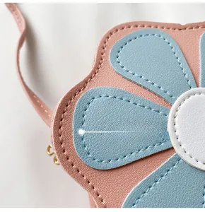 Detail showing high-quality stitching on the pink flower-shaped PU leather crossbody bag