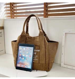 Brown corduroy tote bag showing large capacity with an iPad inside for size scale