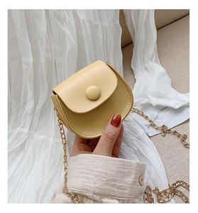 Detail of yellow mini semi-circle crossbody bag with gold chain strap and fine stitching