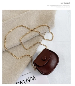 Detail of coffee brown PU leather mini round bag with gold chain and round buckle