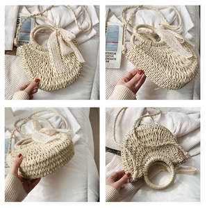 Detail view of woven straw bag with ring handle, lace bow, and braided shoulder strap