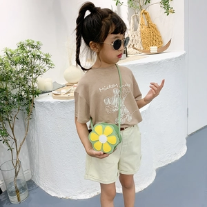 Kids green flower crossbody bag paired with a brown cartoon t-shirt for a stylish look