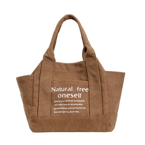 Large brown canvas tote bag with white inspirational text for daily use or travel
