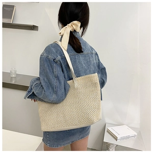 Detailed view of large capacity woven tote bag with premium leather shoulder straps