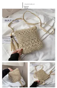 Detail of square beige straw bag with crochet patterns, tassels, and wooden beads