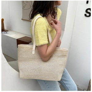 Detail shot of large linen tote bag with woven texture and slim straps for summer style